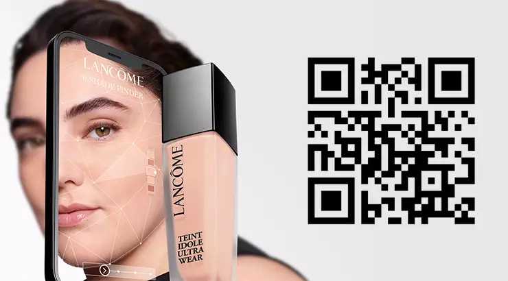 A smartphone displaying a virtual shade finder app for Lancome foundation, next to a bottle of Lancome Teint Idole Ultra Wear foundation and a QR code.