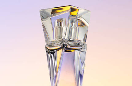 A stylish glass perfume bottle with a geometric design against a softly blended pastel background.