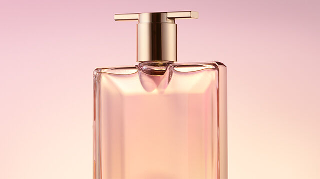 A bottle of perfume labeled "Midnight Rose" with a rose detail, set against a soft purple backdrop.