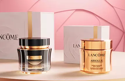 A stylish display of luxury skincare products in elegant packaging, positioned on a circular platform against a soft pink background.